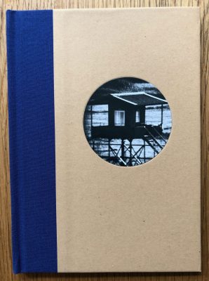 The photobook cover of DMZ by Michael Kenna. Hardback in beige with cobalt blue binding.