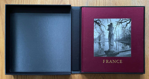 The photography book cover of France by Michael Kenna. Hardback book in burgundy with clamshell black box. Signed.