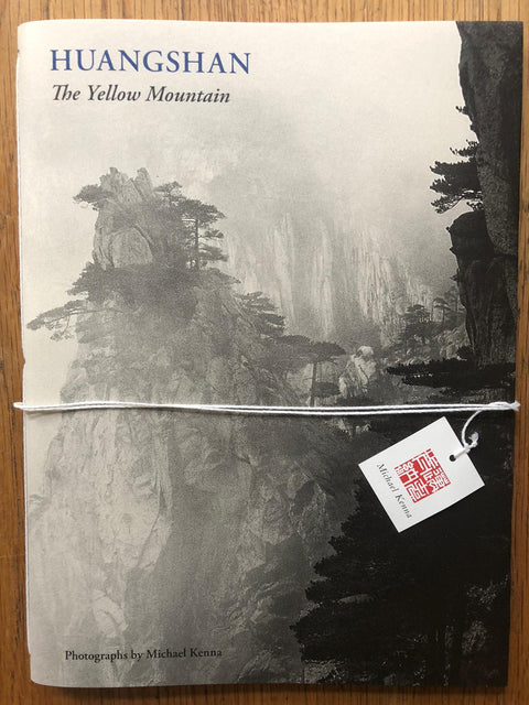 The photography book cover of Huangshan: The Yellow Mountain by Michael Kenna. Paperback with B&W image of trees on a cliff edge.