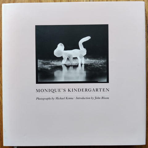The photography book cover of Monique's Kindergarten by Michael Kenna. Hardback in white. Signed.