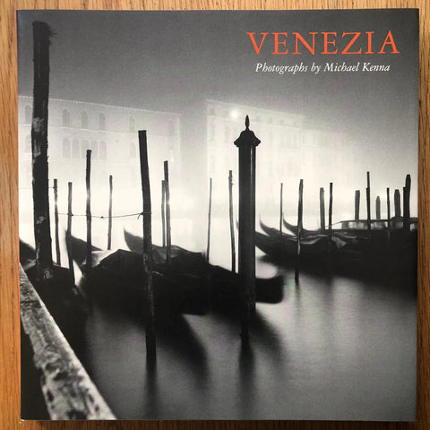 The photography book cover of Venezia by Michael Kenna. Hardback in black and white with title in red. Signed.