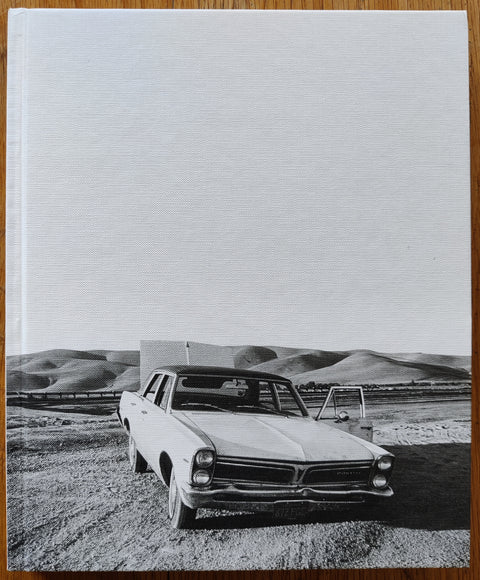 The photobook cover of The White Sky by Mimi Plumb. In hardcover white and black.