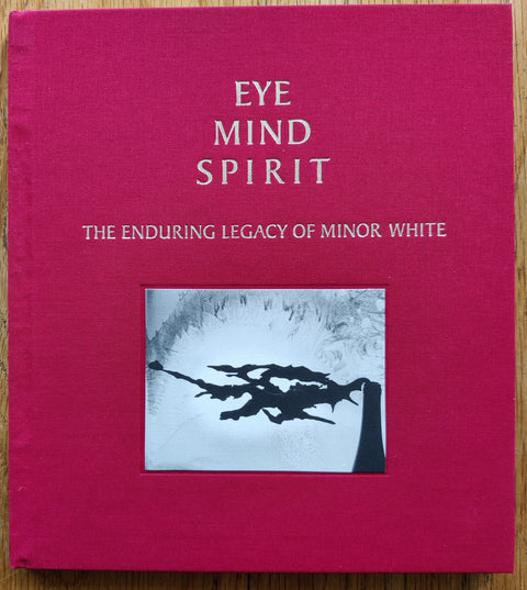 The photobook cover of EYE MIND SPIRIT: The Enduring Legacy of Minor White by Minor White. In hardcover red.