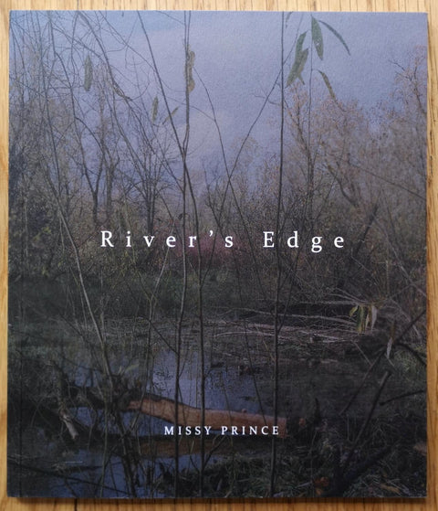 The photography book cover of  River's Edge by Missy Prince. In softcover with a lake and a forest.