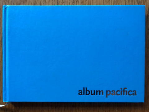 The photobook cover of Album Pacifica by Mohini Chandra. Hardback in cobalt blue with title in the bottom right corner.