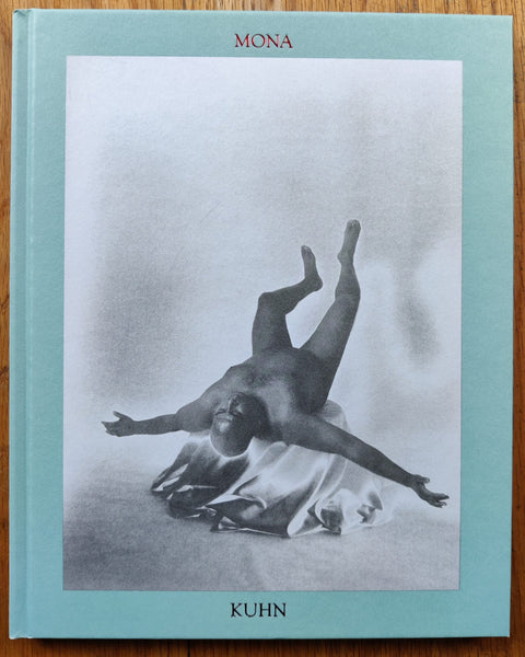 The photography book cover of Study by Mona Kuhn. Hardback with light blue border, B&W image of someone lying on their back with arms out.