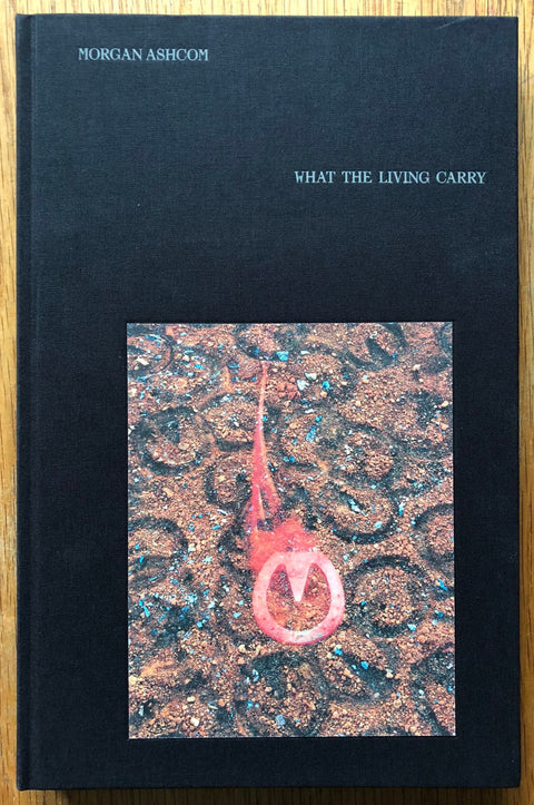 The photography book cover of What the Living Carry by Morgan Ashcom. Hardback black.