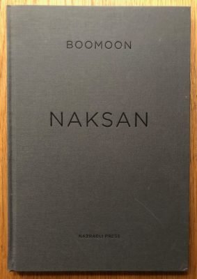 The photography book cover of Naksan by Boomoon. Hardback in grey.