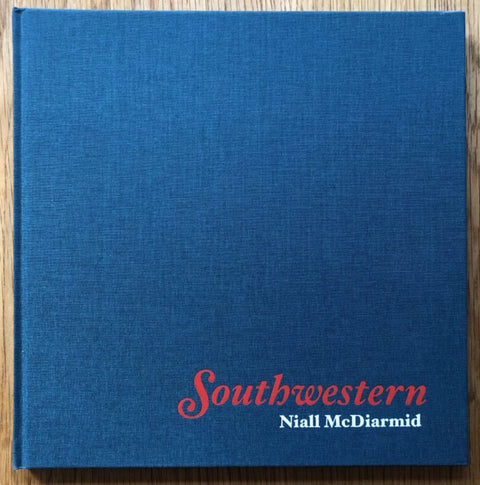 The photography book cover of Southwestern by Niall McDiarmid. Hardback in dark blue with red title.