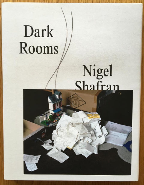 The photography book cover of Dark Rooms by Nigel Shafran. In dust jacketed softcover white.