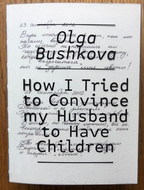 The photography book cover of How I tried to convince my husband to have children by Olga Bushkova. Paperback in white with title on transparent pvc over a hand written letter.