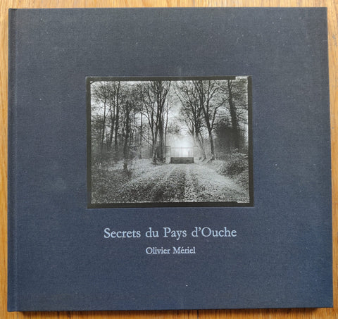 The photography book cover of Secrets du Pays d'Ouche by Olivier Meriel. Hardback in navy blue.