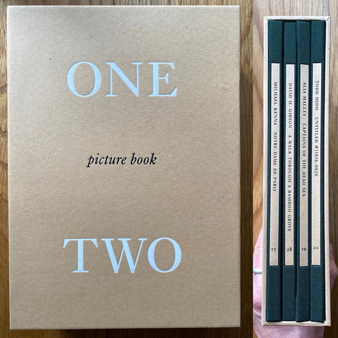 The cover of set of four One Picture photography books. Hardback books in a hardcover cardboard colour case. Signed.