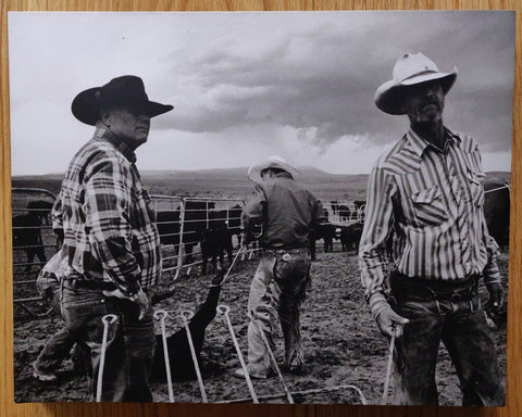 The photography book cover of Open Range by John Langmore. Hardback in B&W with three cowboys on the cover.