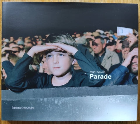 The photography book cover of Parade by Mark Neville. In dust jacketed hardcover grey.