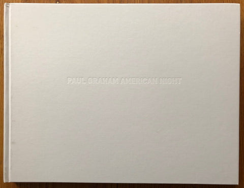 The photography book cover of American Night by Paul Graham. Hardback in white with white text.