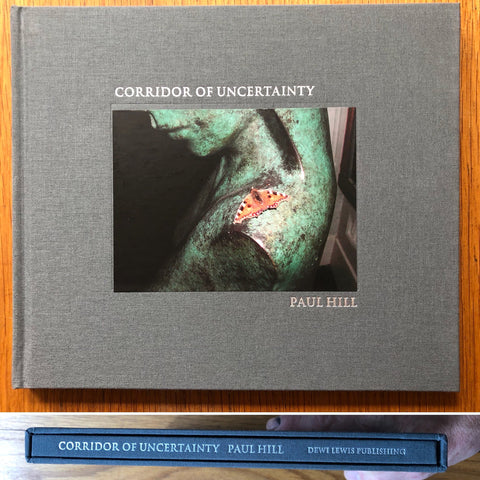 The photography book cover of Corridor of Uncertainty by Paul Hill. Hardback with grey border, photograph of moth in the middle.