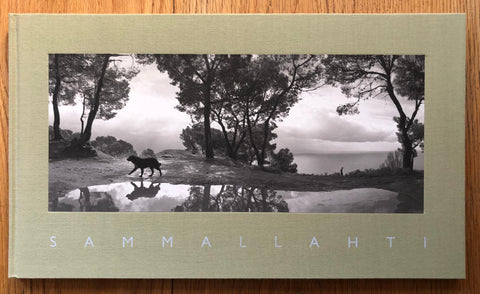 The photography book cover of Sammallahti by Pentti Sammallahti. Hardback with beige border and photograph of a dog by a large puddle. Signed.
