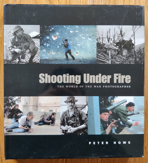 The photobook cover of Shooting Under Fire by Peter Howe. In dust jacketed hardcover.