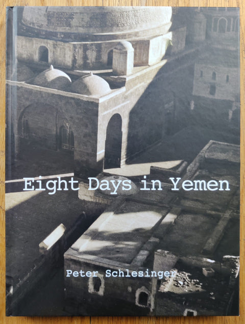 The photography book cover of Eight Days in Yemen by Peter Schlesinger. Hardback image of a building. Signed.