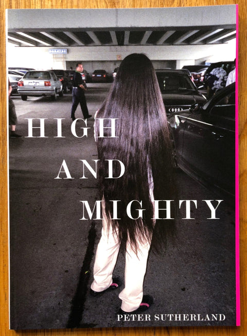 The photography book cover of High and Mighty by Peter Sutherland. Softcover image in car park.
