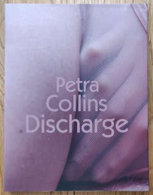 The photography book cover of Discharge by Petra Collins. Paperback with body close up image on cover.