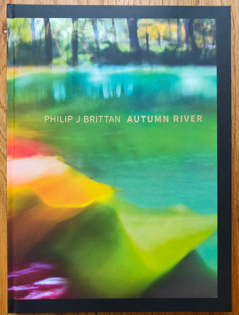 The photography book cover of Autumn River by Philip J Brittan. Hardback with a very colourful cover. Signed.