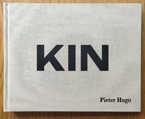 The photography book cover of Kin by Pieter Hugo. Hardback in white with large black centred title.