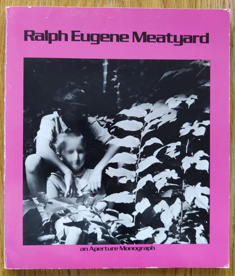 The photography book cover of Ralph Eugene Meatyard. In softcover pink.