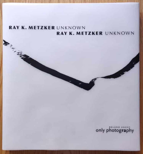 The photography book cover of Unknown by Ray K. Metzker. Hardback in white with black text.