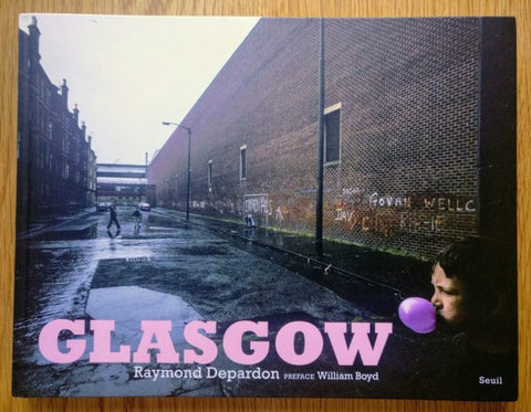The photography book cover of Glasgow by Raymond Depardon. Hardback with pink title and a boy blowing bubble gum.