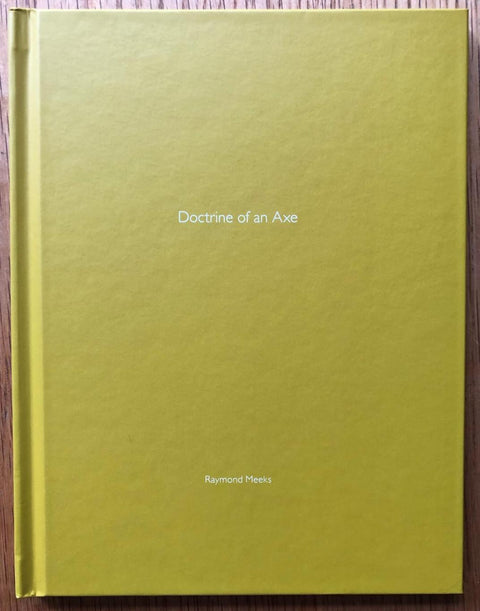 The photobook cover of Doctrine of an Axe (One Picture Book) by Raymond Meeks. Hardback in yellow. Signed.