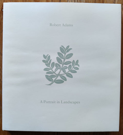 The photography book cover of A Portrait in Landscapes by Robert Adams. In dust jacketed hardcover green