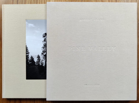 The photography book cover of Pine Valley by Robert Adams. Cream cover and cream slipcase cover. Hardback.