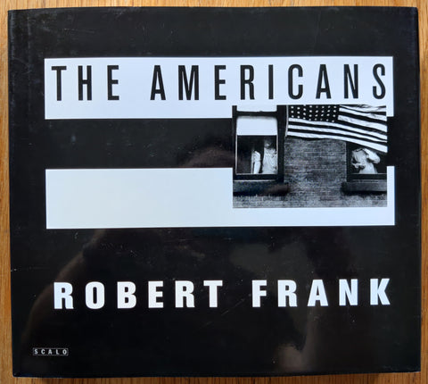 The photobok cover of The Americans by Robert Frank . In dust jacketed hardcover black.