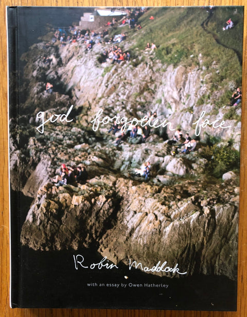 The photography book cover of God Forgotten Face by Robin Maddock. Hardback cover with photo of rock edge.