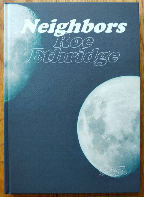The photography book cover of Neighbors by Roe Ethridge. Hardback with photo of the moon on the cover. Signed.