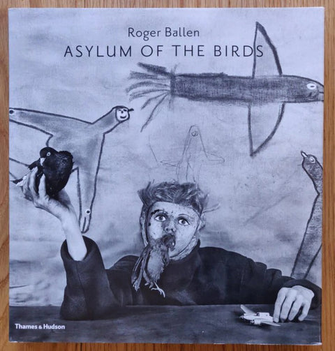 The photography book cover of Asylum of the Birds by Roger Ballen. Hardback with drawings on the cover.