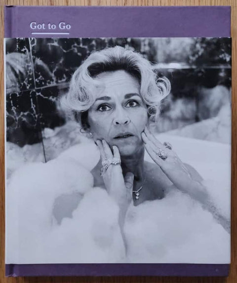 The photography book cover of Got to Go by Rosalind Fox Solomon. Hardback in purple with B&W image of a woman in a bath on the cover.