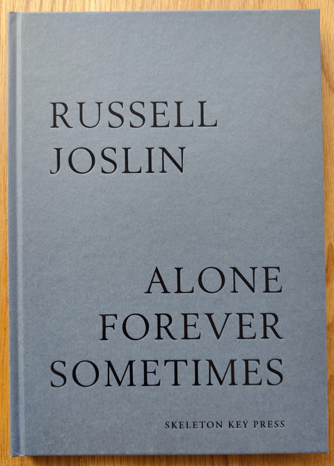 The photography book cover of Alone Forever Sometimes by Russel Joslin. Hardback in grey. Signed.