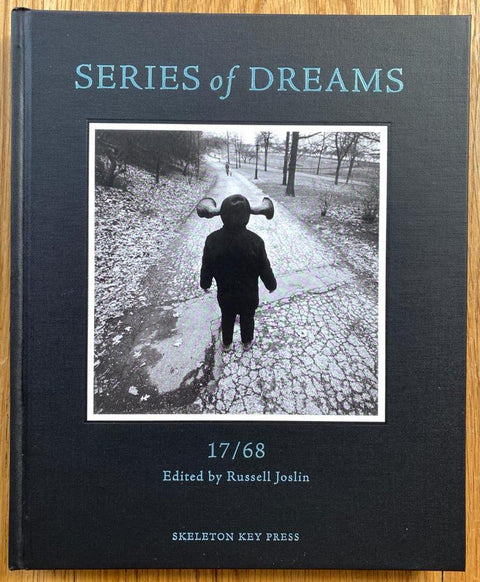 The photobook cover of SERIES OF DREAMS: Selections from 17 Years / 68 Issues of Shots Magazine edited by Russell Joslin. In hardcover black.