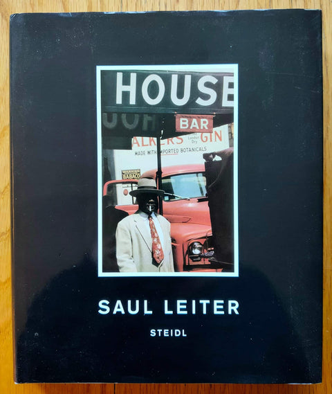 The photography book cover of Saul Leiter by Saul Leiter. Hardback in black with centred image.