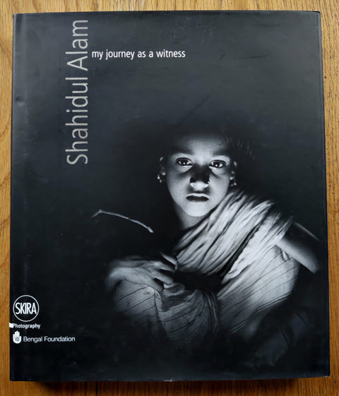 The photography book cover of My Journey as a Witness by Shahidul Alam. Hardback with image of a young child looking into the camera.