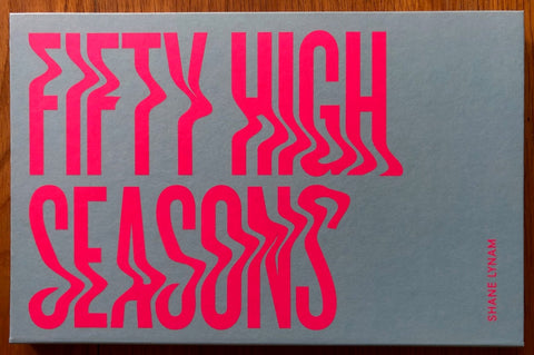 The photography book cover of Fifty High Seasons by Shane Lynam. Hardback with large pink title.
