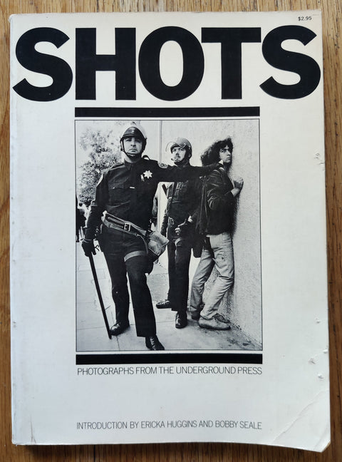 The photobok cover of Buy Shots: Photographs From the Underground Press. In softcover white.