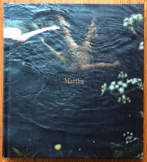 The photography book cover of Martha by Sian Davey. Hardback photograph of someone in water.