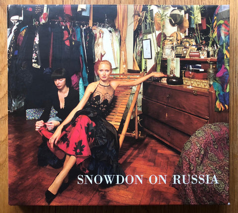 The photography book cover of Snowdon on Russia by Lord Snowdon. Hardback with image of someone in a red and black dress looking into the camera. Signed.
