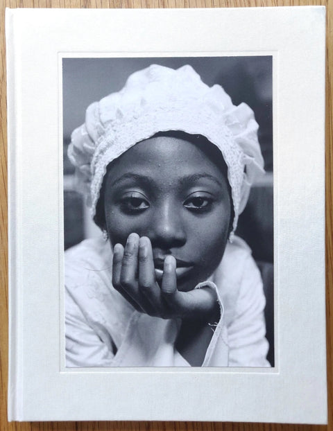 The photography book cover of Congregation by Sophie Green. Hardback with a woman on the cover, leaning her head on her hand.