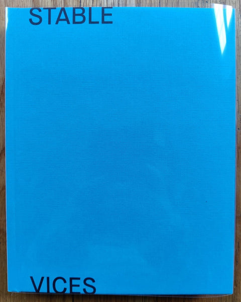 The photography book cover of Stable Vices by Joanna Piotrowska. Hardback in light blue. Signed.