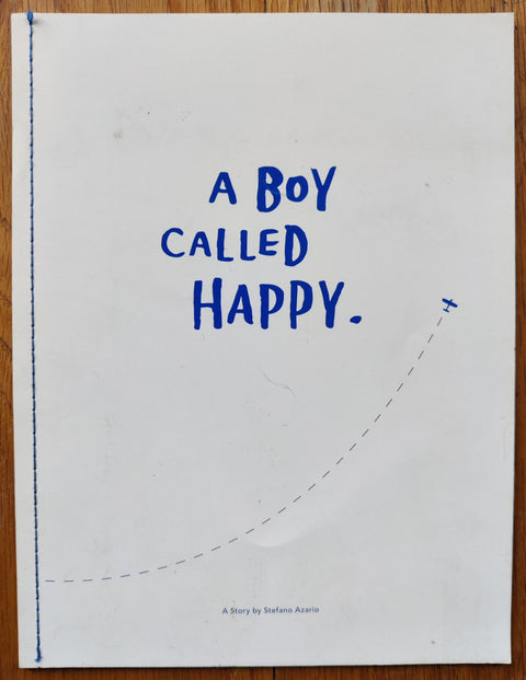 The phtoography book cover of A Boy Called Happy. by Stefano Azario. Paperback white with blue title and a small plane flying.
